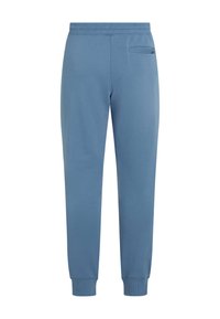 Blue cotton joggers with a tapered design, elastic waistband, ribbed cuffs, and a small back pocket for storage. Smooth texture.
