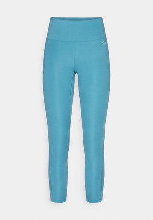 Turkise leggings med høy midje, glatt tekstur og sidelommer. Har en diskret logo på midjeområdet.