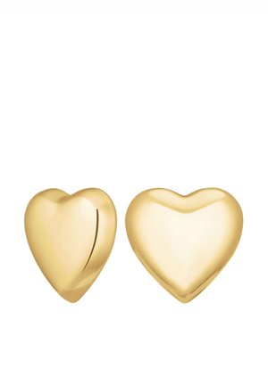 Złote kolczyki w kształcie serca o gładkiej, błyszczącej powierzchni, z jednym z nich posiadającym niewielkie wcięcie, podkreślającym ich zabawny design.