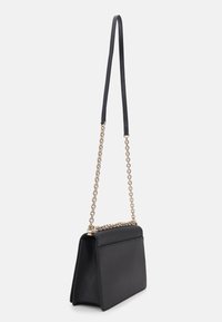 A stylish black handbag with a structured design, featuring a gold chain handle and a sleek, minimalist aesthetic.