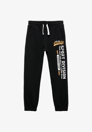 Zwarte sweats in een katoenmix, met een trekkoord in de taille, aansluitende enkelboorden en bedrukte tekst op één been in oranje en wit.