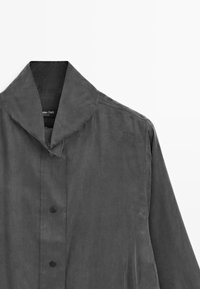 Gray, textured coat with a wide collar, featuring a button closure and no visible patterns. Smooth fabric with a minimalist design.