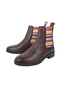 Brązowe skórzane botki za kostkę z elastycznymi panelami bocznymi, ozdobione kolorowymi paskami. Płaska czarna gumowa podeszwa i pętelka z tyłu.