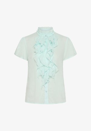 Helles mintgrünes Kurzarmblus mit hohem Rüschensaum und einer vertikalen Rüsche an der Vorderseite. Knöpfe am Ausschnitt.