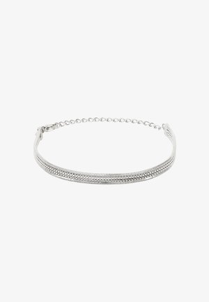 Bransoletka w srebrzystym kolorze z łańcuszkiem w kształcie węża i regulowanym zapięciem na białym tle.