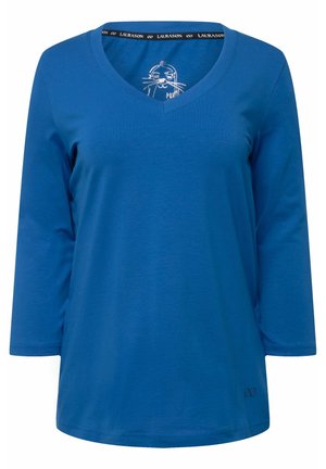 Blaues Langarmshirt mit V-Ausschnitt aus weicher Baumwolle. Verfügt über ein einfaches Katzendesign im Kragen und ein kleines Logo am Saum.