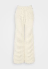 Kremowe spodnie o szerokich nogawkach wykonane z dzianiny o otwartym splocie. Posiadają miękki elastyczny pas z regulacją na sznurek.