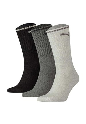 Trois paires de chaussettes côtelées mi-mollet en noir, gris foncé et gris clair avec un logo près du bord supérieur sur fond blanc.