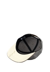 Cap with a cream bill and gray fabric body. Features a black band and four ventilation holes on each side, with decorative stitching on the bill.