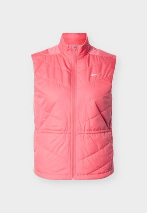 Spilgtā rozā pūkaina vestes ar augstu apkakli, priekšējo rāvējslēdzēju un zivju kaula dūrienu rakstu. Nike logotips balts, kreisajā augšējā pusē.