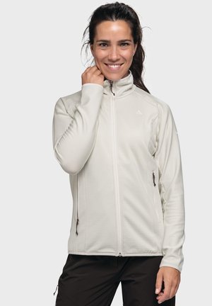 Hellbeige Zip-Jacke aus strukturiertem Stoff, mit seitlichen Taschen und hohem Kragen. Slim-Fit-Design mit dezenten Branding-Details.