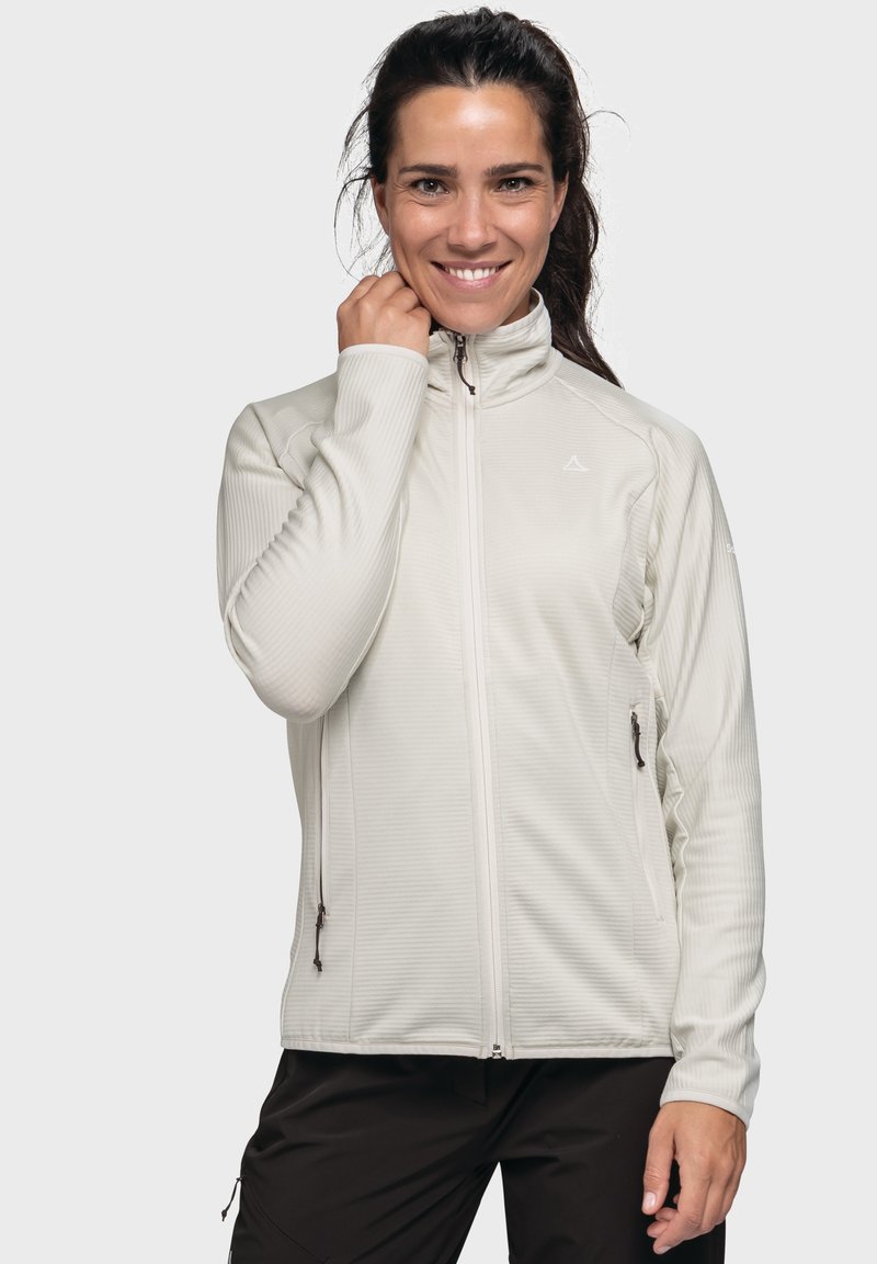 Hellbeige Zip-Jacke aus strukturiertem Stoff, mit seitlichen Taschen und hohem Kragen. Slim-Fit-Design mit dezenten Branding-Details.