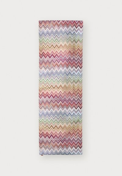 Patterned fabric with a zigzag design in red, pink, purple, green, and beige hues. Soft texture, rectangular shape, and thin material.