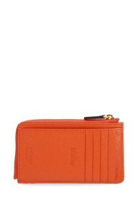 Orange RFID-blocking wallet with a zip closure, textured surface, six card slots, and embossed logo detailing. Compact rectangular design.