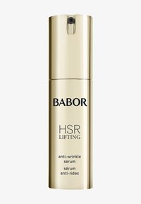 Złota cylindryczna butelka z czarnym napisem, oznaczona jako "BABOR HSR LIFTING serum przeciwzmarszczkowe". Gładka powierzchnia, dozownik z pompką na górze.