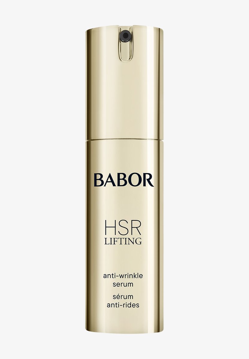 Złota cylindryczna butelka z czarnym napisem, oznaczona jako "BABOR HSR LIFTING serum przeciwzmarszczkowe". Gładka powierzchnia, dozownik z pompką na górze.