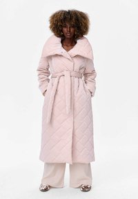 Roze gewatteerde jas met een hoge kraag en brede revers, vastgemaakt met een riem op de taille. Zakjes op de heupen en een soepele textuur.