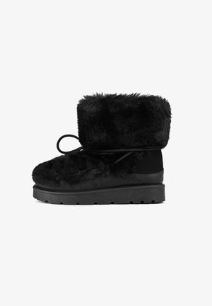 Black ankle boot made of faux fur with a textured surface, a flat rubber sole, and a rounded toe, featuring a tied lace detail.