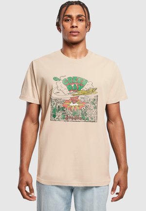 Beige cotton t-shirt featuring a colorful graphic print with "Green Day" text, clouds, and a floral design. Short sleeves, crew neck.