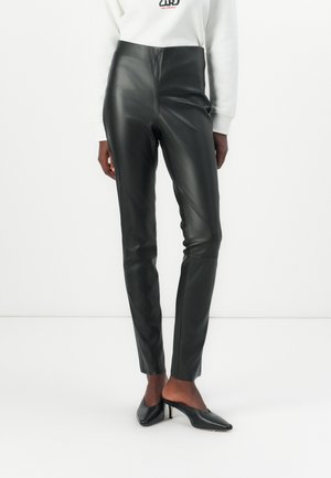 Black leather pants with a high waistband, slim fit, and shiny texture. Pairing with black heeled shoes.