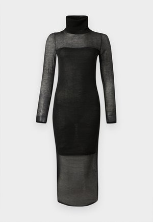 Pitkä musta läpikuultava mekko, jossa on pitkät hihat, poolokaulus ja musta, läpikuultamaton vuori rintakehästä keskireiteen saakka.