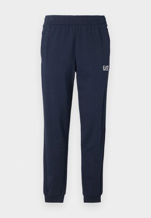 Navy blue sweatpants with an elastic waistband and cuffs. Features a small white logo on the left leg. Made from a soft, stretchy material.