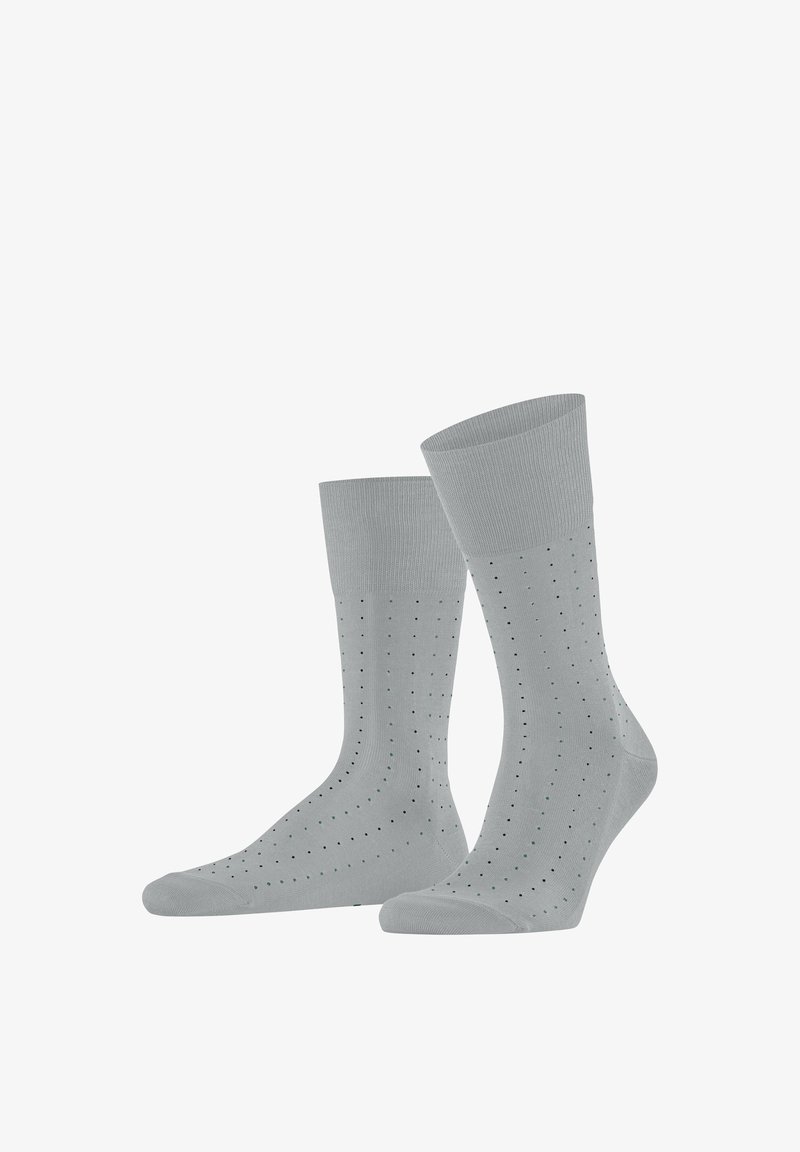 Chaussettes gris clair mi-mollet avec de petits points noirs et verts régulièrement espacés en lignes verticales courbes.
