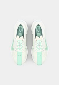 Nike hardloopschoenen met een mesh bovenwerk in roomwit en mintgroen, voorzien van een gevoerde tong, veters en kenmerkende swoosh-accenten.