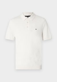 Bílá polokošile s krátkým rukávem a třemi knoflíky, na levé hrudi malá červenobílomodrá ikona Tommy Hilfiger.