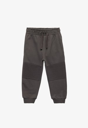 Pantalon de jogging gris foncé avec taille élastique et cordon de serrage, présentant des accents de panneaux côtelés au niveau des genoux, fabriqué en tissu doux en mélange de coton.