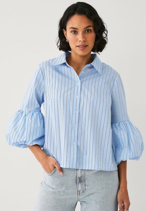 Light blue button-up shirt with white vertical stripes, puffed sleeves, and a classic collar. Fabric appears smooth with a crisp finish.