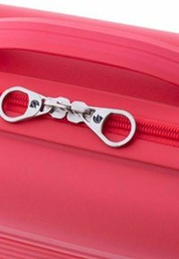Close-up of two silver zipper pulls on a red fabric zipper, showing the zipper teeth and part of the surrounding material.