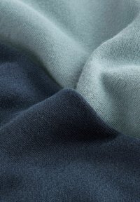 Knit fabric featuring three sections: dark navy, muted teal, and soft light blue. Smooth texture with a fine weave and subtle color transitions.