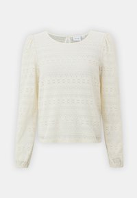 Haut en dentelle crème à manches longues avec un col rond, texture à motifs et manches froncées, doté d'une ouverture en forme de clé à l'arrière.