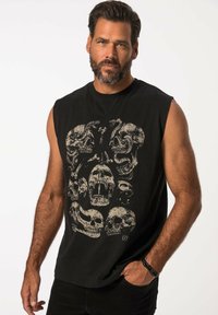 Schwarzes ärmelloses T-Shirt mit einem grafischen Design aus mehreren Schädeln in Beige, aus Baumwolle mit einer weichen Textur und lockerer Passform.