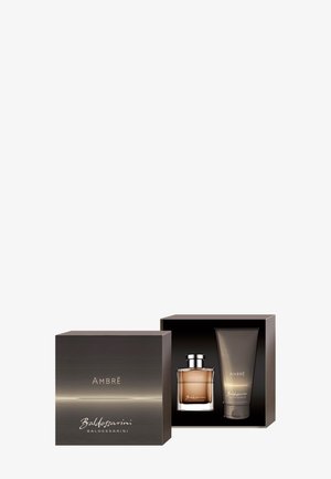 Coffret cadeau Baldessarini Ambré avec flacon de eau de Cologne et tube assorti dans un emballage élégant noir et aux tons ambrés.