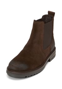 Bottines Chelsea en suède marron avec panneaux élastiques sur les côtés, languette à l'arrière et semelle en caoutchouc noir texturé.