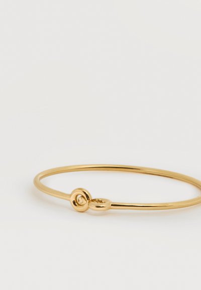 Λεπτό βραχιόλι-μαντέλα από χρυσό με στρογγυλό κούμπωμα, σε απλό λευκό φόντο.