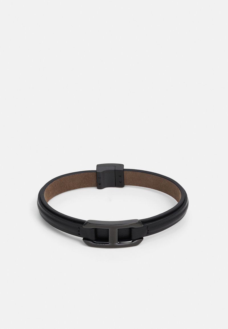 Black leather bracelet with a smooth texture, featuring a rectangular metal clasp and a contrasting brown inner lining.