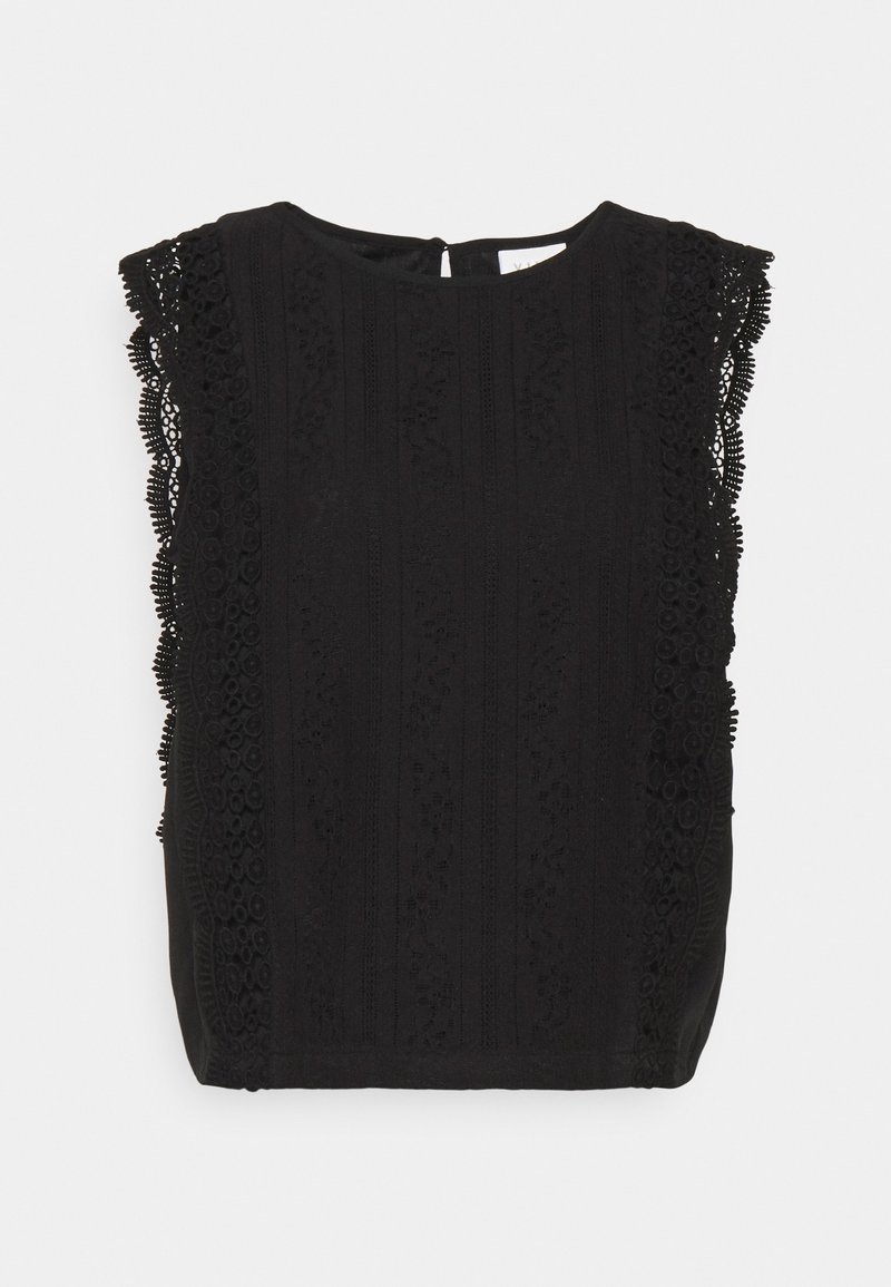 Top noir sans manches avec des détails en dentelle complexes au niveau des épaules et des motifs texturés verticaux à l'avant. Fermeture en œillet dans le dos.