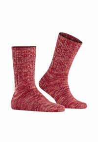 Calzini rossi a fantasia con una texture a coste, che mostrano diverse sfumature di rosso e un design morbido e lavorato a maglia. Altezza fino alla caviglia, adatti per un abbigliamento informale.