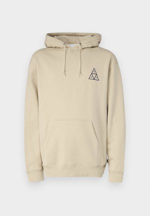 Hooded beige sweatshirt made of soft material, featuring a front pocket and a triangle logo in navy on the left chest area.