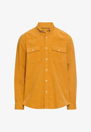 Langærmet skjorte med knapper i sennepsgul corduroy. Har to brystlommer og krave. Glat tekstur med en klassisk pasform.