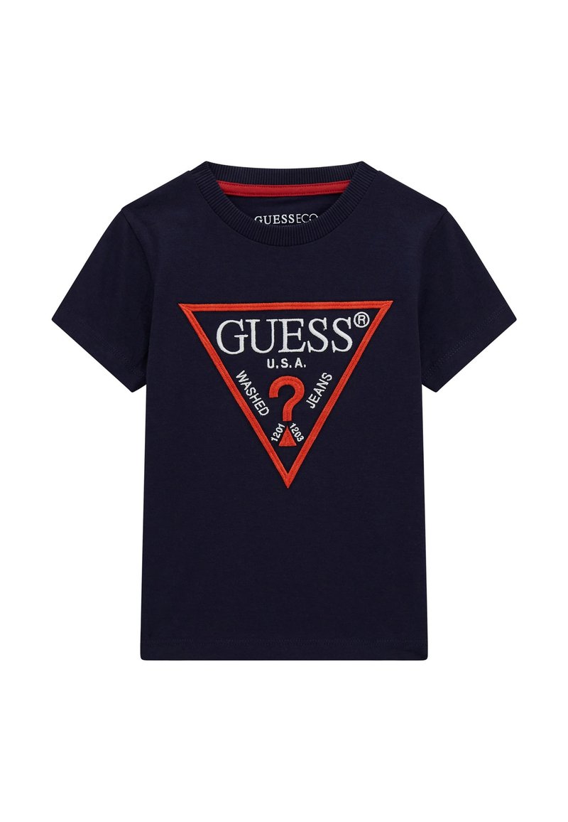 Merenneito sininen puuvillapaita, jossa on punainen ja valkoinen kolmio-logo sekä tekstit "GUESS U.S.A." ja "WASHED JEANS", tekstuuri-ompeleet.