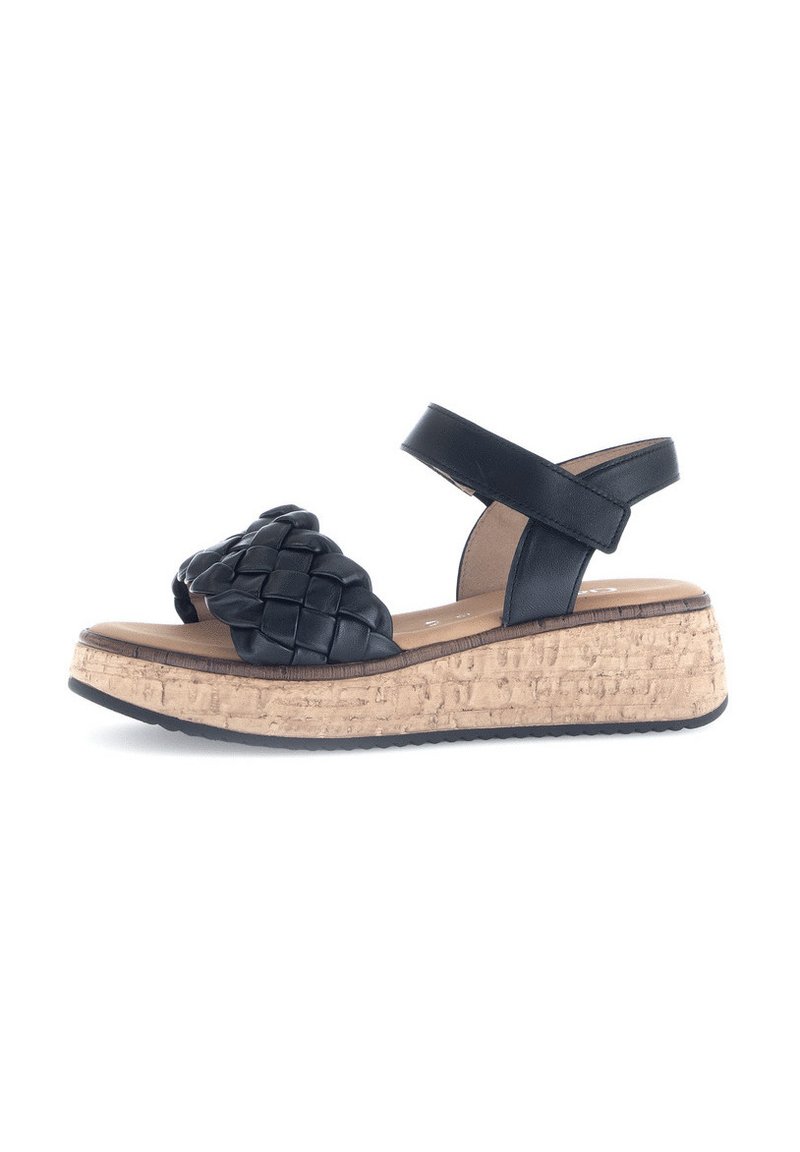 Sandali neri in pelle intrecciata con suola in sughero a zeppa. Caratterizzati da una cinturino alla caviglia e una soletta testurizzata per il comfort.