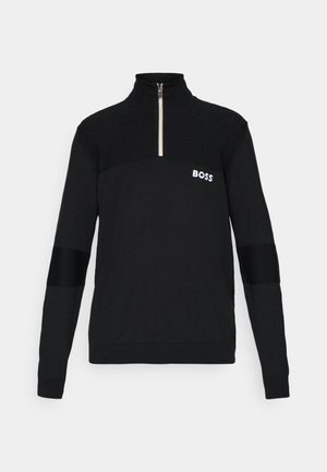 Melna pusē-zips džemperis, izgatavots no teksturētas auduma, ar ribotu augšējo daļu un baltu "BOSS" logotipu uz krūtīm.