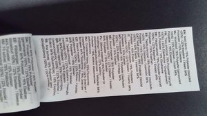 Clothing care label with multi-language text detailing fabric composition: 78% recycled polyester, 22% elastane, various language specifications.