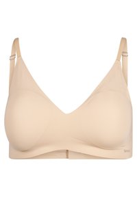 Beige wireless bra with triangular cups, soft fabric, adjustable straps, and a smooth texture. Features a subtle logo at the band.