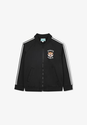 Giacca bomber nera in un tessuto liscio. Presenta strisce bianche sulle maniche, un logo a forma di tigre, chiusura con zip e due tasche laterali.