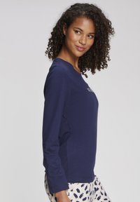 Navy long-sleeve t-shirt with a round neckline, made of soft material, featuring a simple front design and relaxed fit.
